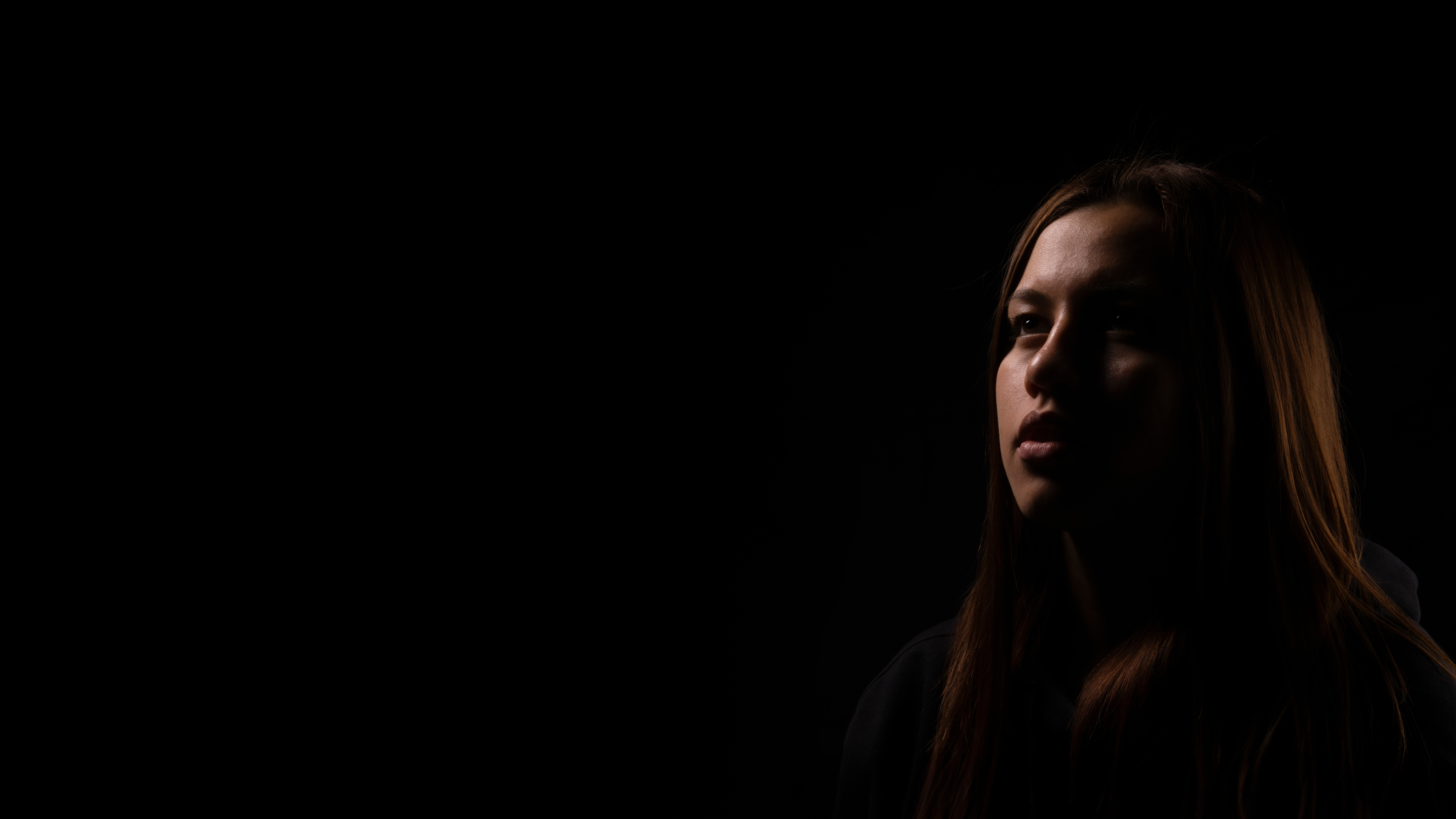 camera with lenses floating in a dark background, highlighted by moody blue lighting
